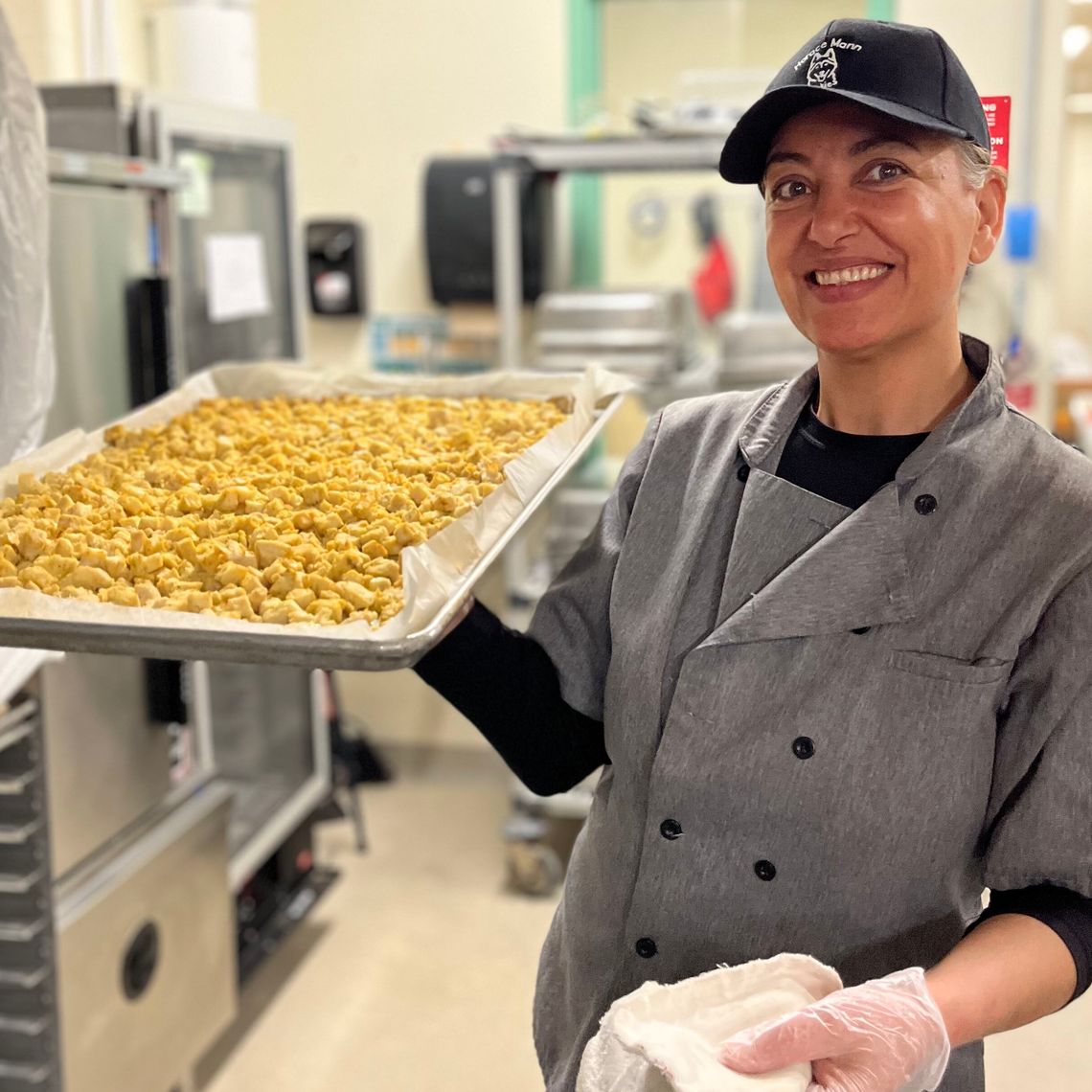 School nutrition worked holding tray of food and posing