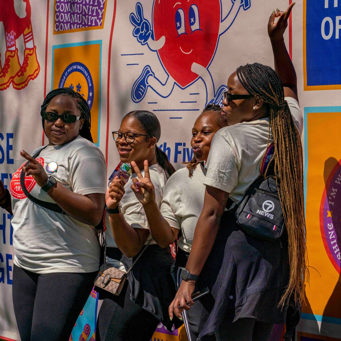 four women pose in front of the photo mural at the 2023 walk