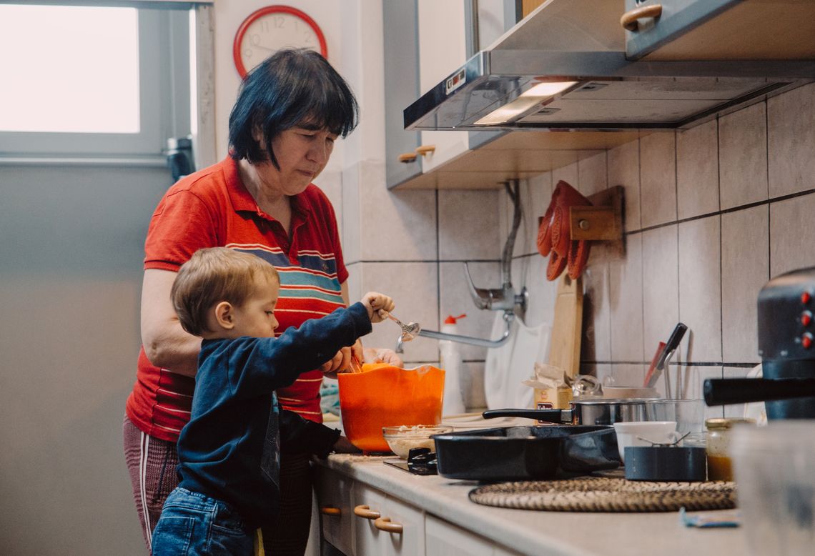 A family cooks in the kitchen