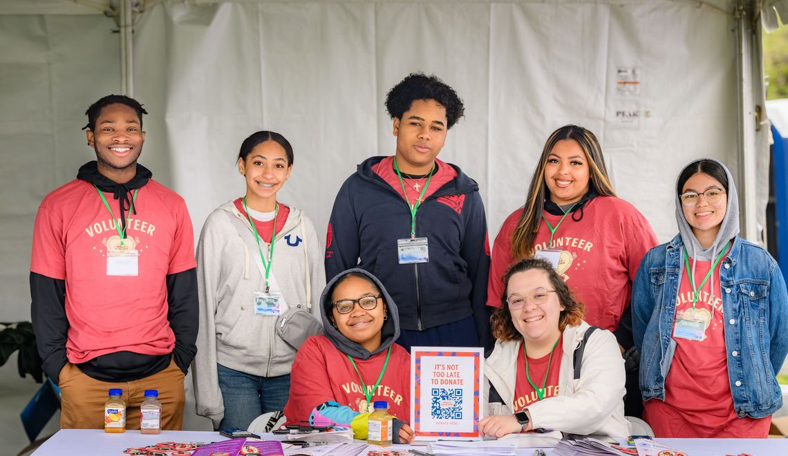 A group of volunteers behind a table at The Walk for Hunger in 2024