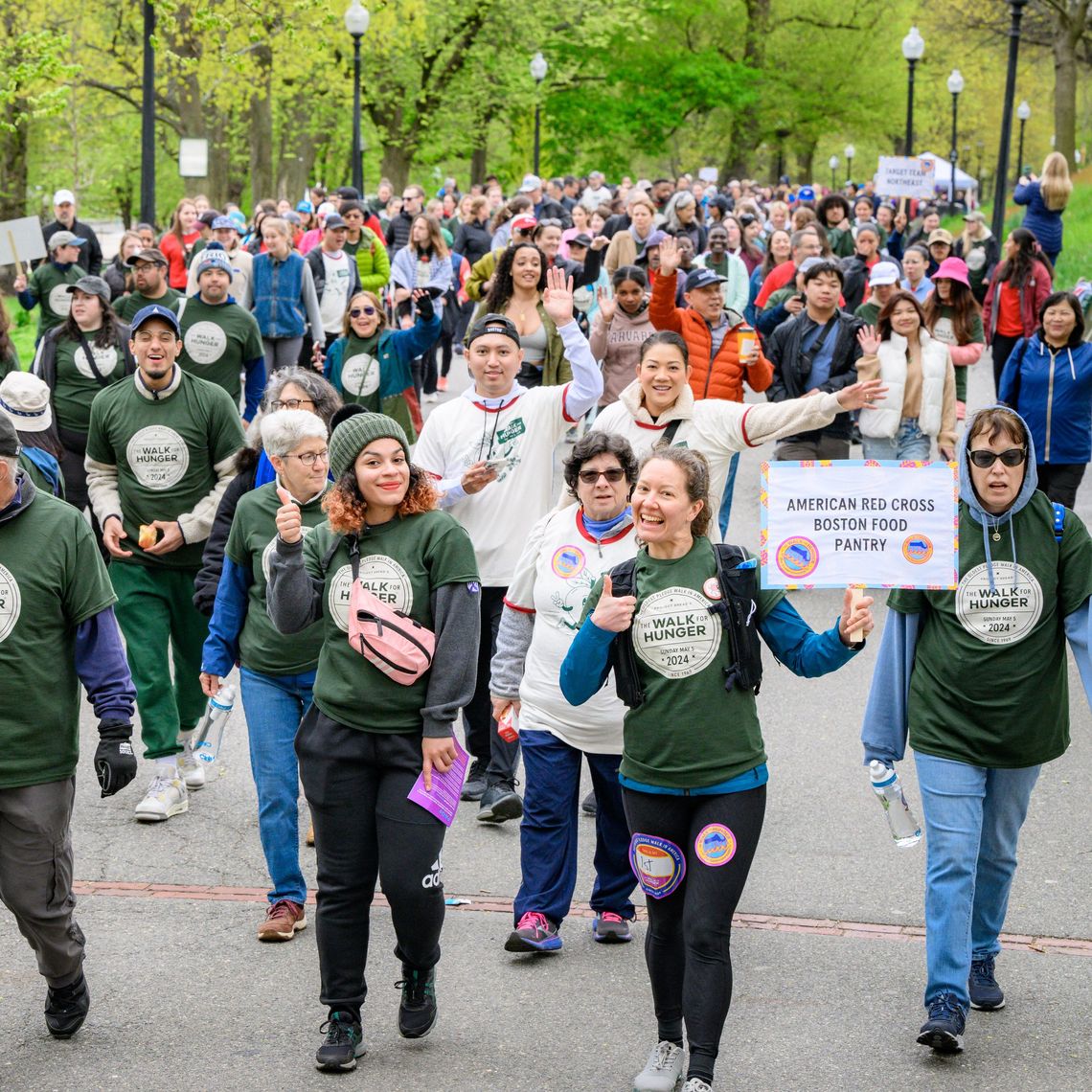 American Red Cross Boston Food Pantry holds team sign walking amongst crowd