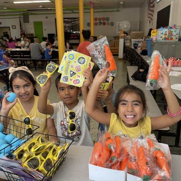 kids in a cafeteria with Summer Eats swag