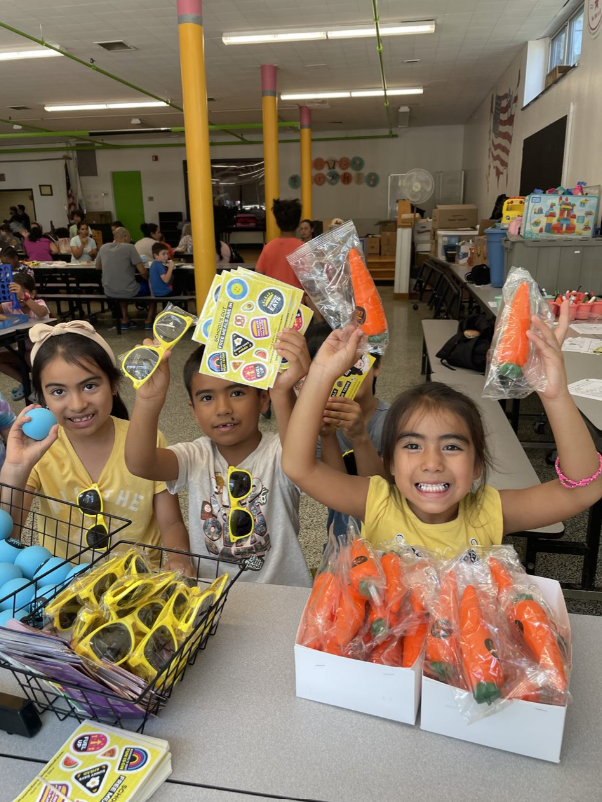 kids in a cafeteria with Summer Eats swag