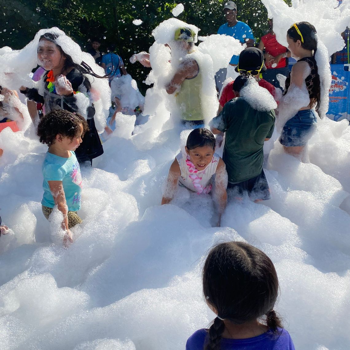 Kids play with foam at a Summer Eats site.