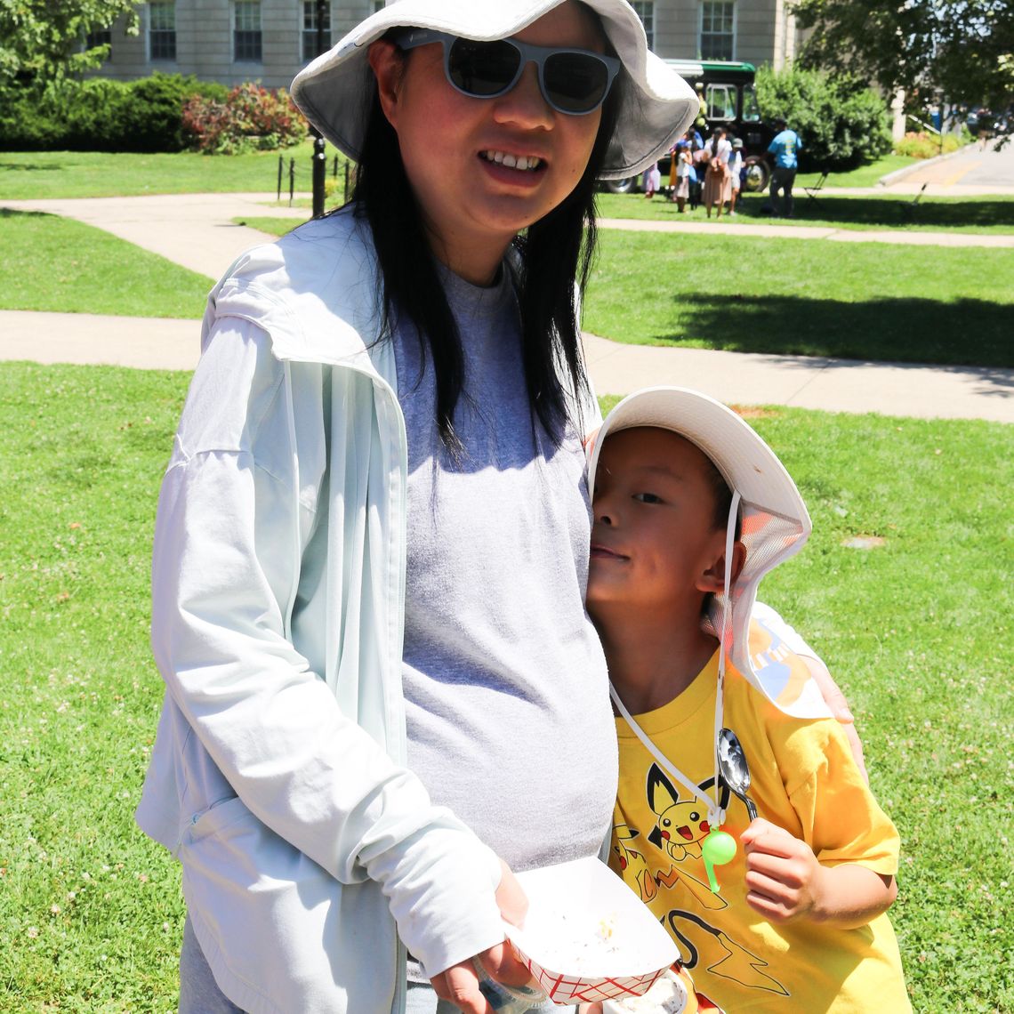 A parent and their kid enjoy the Waltham Summer Eats Kickoff.