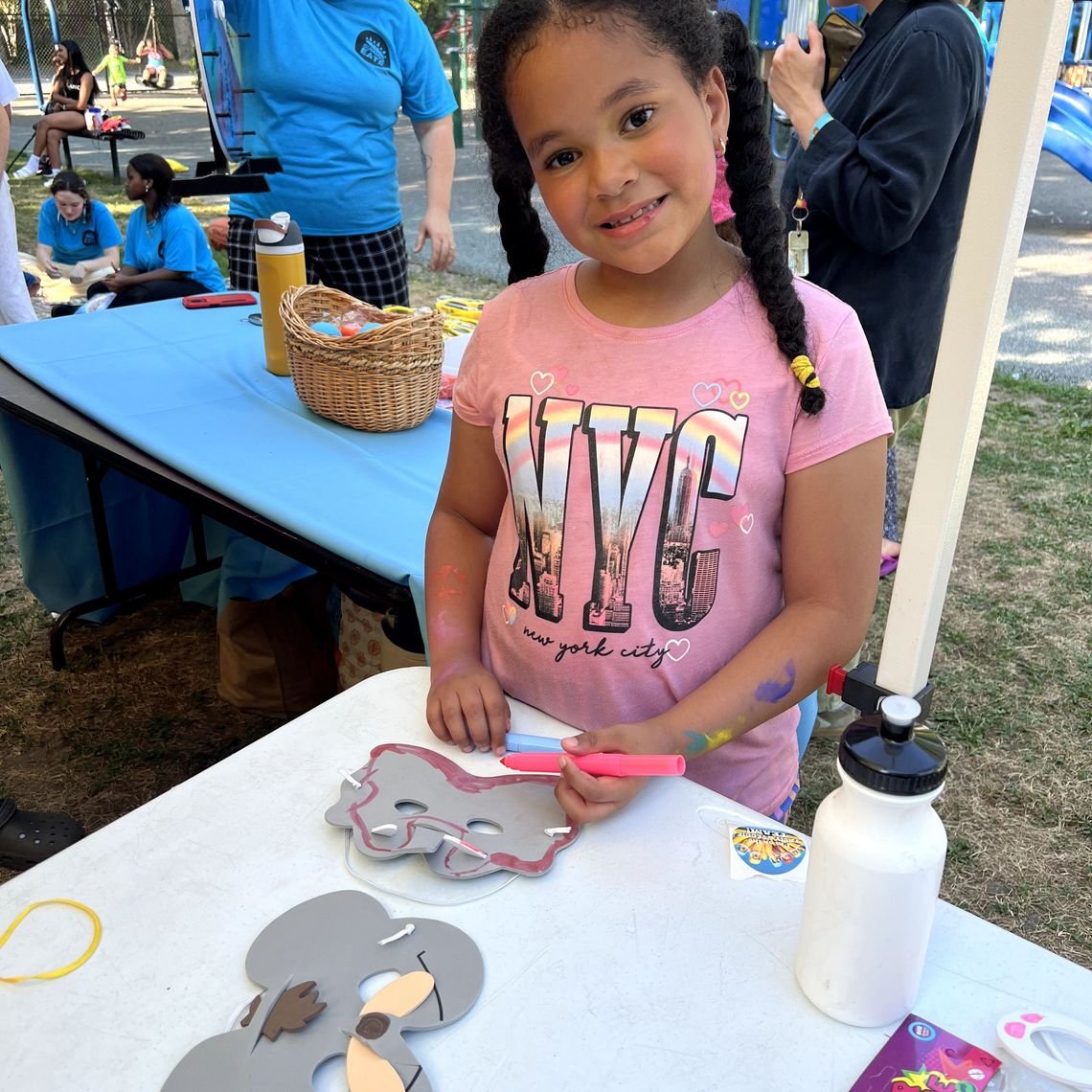 A kid makes a mask at the Salem Summer Eats Kickoff.